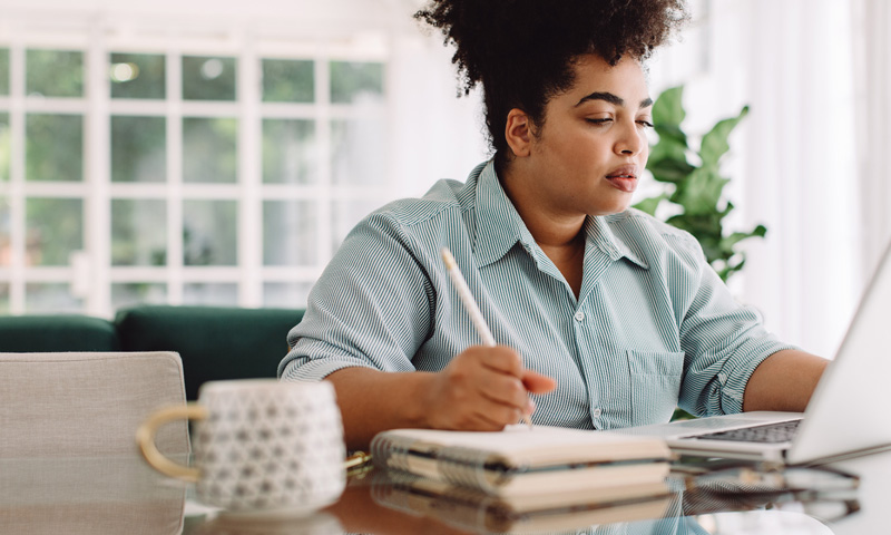 Young woman working at home at a desk